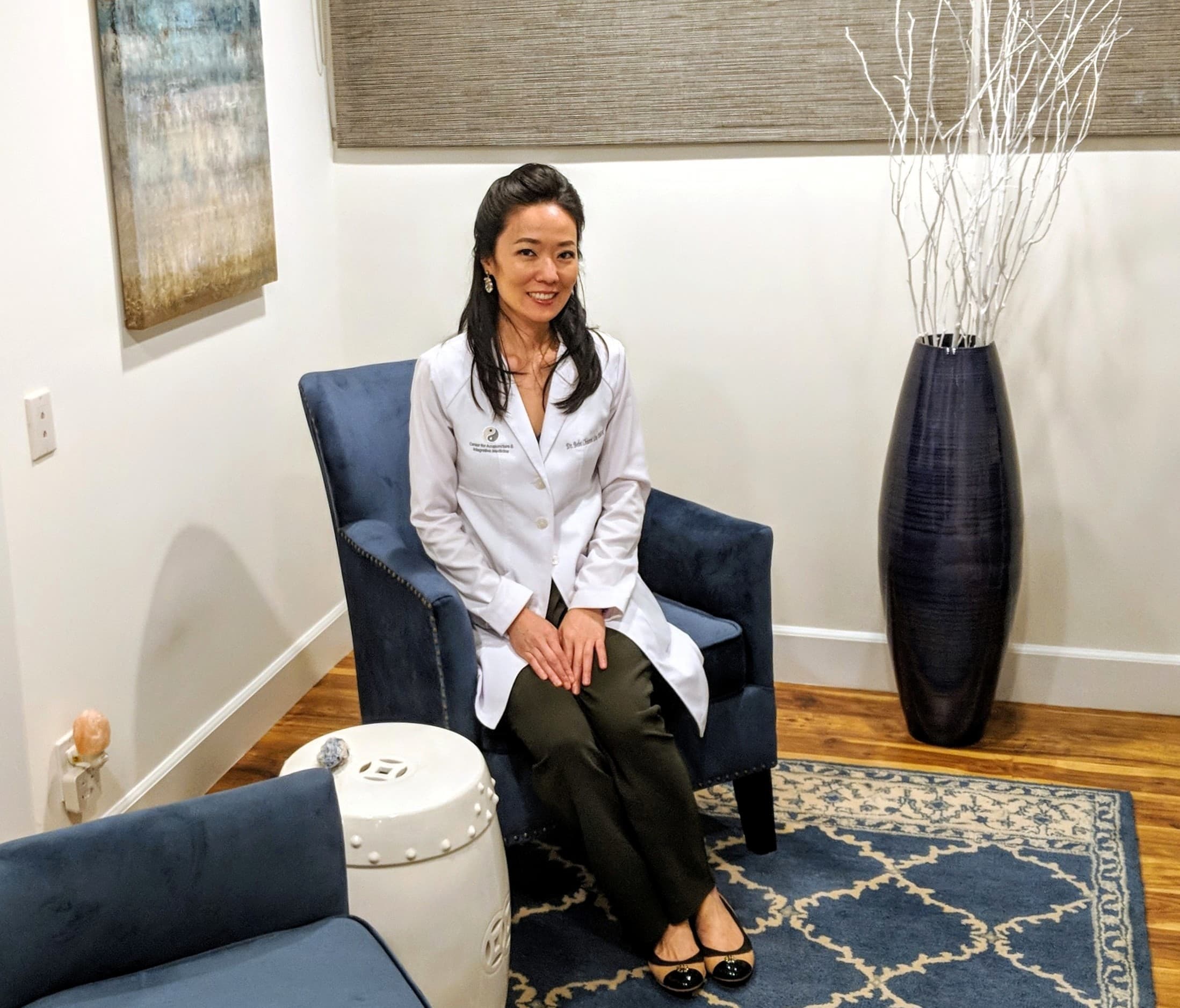 Dr. Chianni Lin in her consultation room discussing stress relief and nervous system balance at Center for Acupuncture & Anti-Aging Medicine in Santa Monica.
