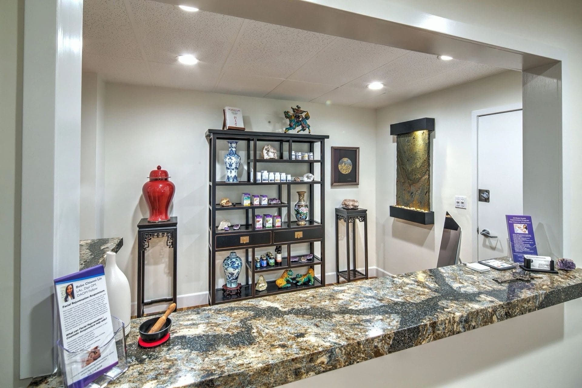 The reception desk, with a display of Chinese herbs and blue-and-white porcelain behind it